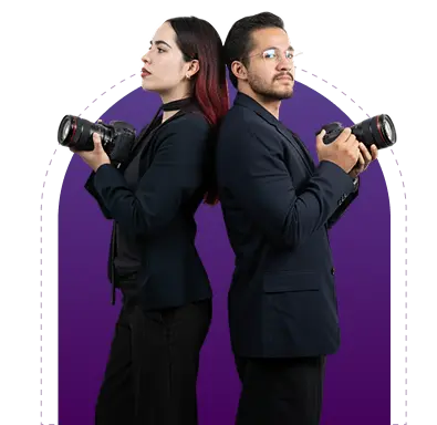 Two professional photographers standing back to back holding cameras, ready for a creative photo shoot.