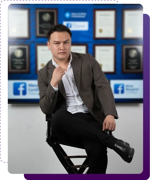 Confident marketing professional sitting on a director’s chair in front of a wall filled with awards and Facebook certifications