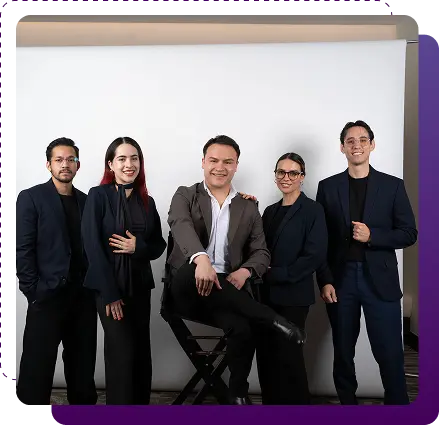 Professional business team posing confidently in a studio setting, representing leadership and collaboration.