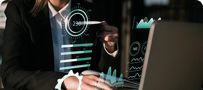 female staff member working in a laptop, several graphs floating