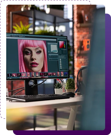 closeup of a photo editing station with a highlight of a woman face while editing