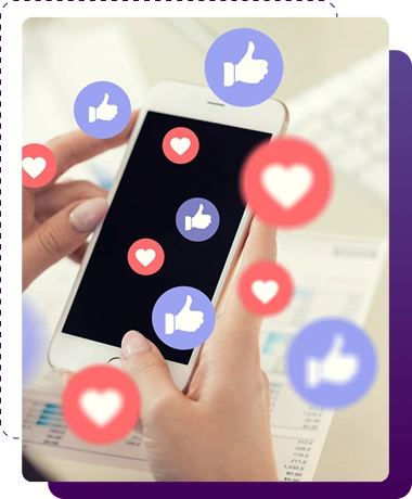 Hands holding a gold smartphone over office documents on a desk, with multiple floating blue like thumbs and red heart icons surrounding the phone.