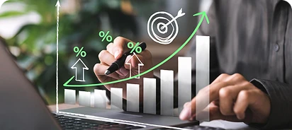 team member working in a laptop, graphs showing over his hands