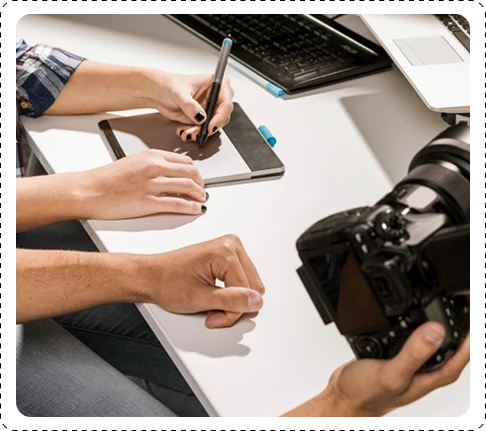 marketing experts reviewing camera photos and taking notes