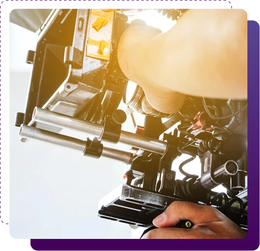 closeup of a professional video camera being controller by staff members